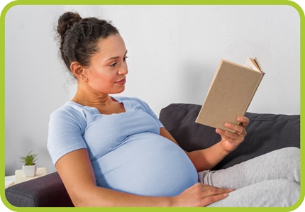 Pregnant woman reads a book